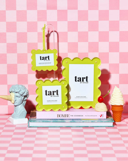 Three green 'tart' branded frames on a pink checkered background with decorative items.