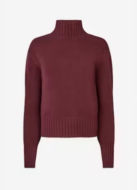 A cropped ribbed-knit turtleneck sweater in a deep burgundy or maroon color, shown against a plain light gray background.