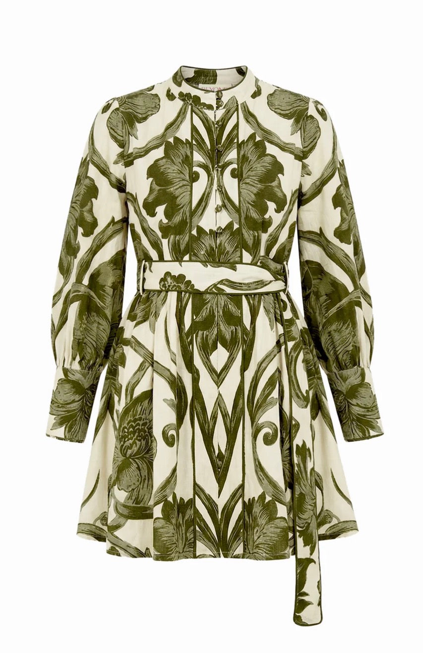 A long-sleeve mini dress with a high mock neck and a self-tie belt, featuring an all-over botanical and scroll pattern in olive green on a warm cream background.