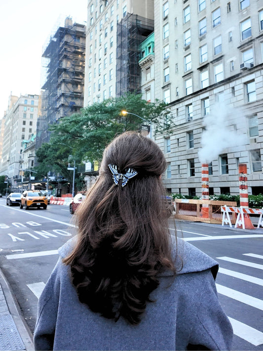 Person with styled hair walking on a city street