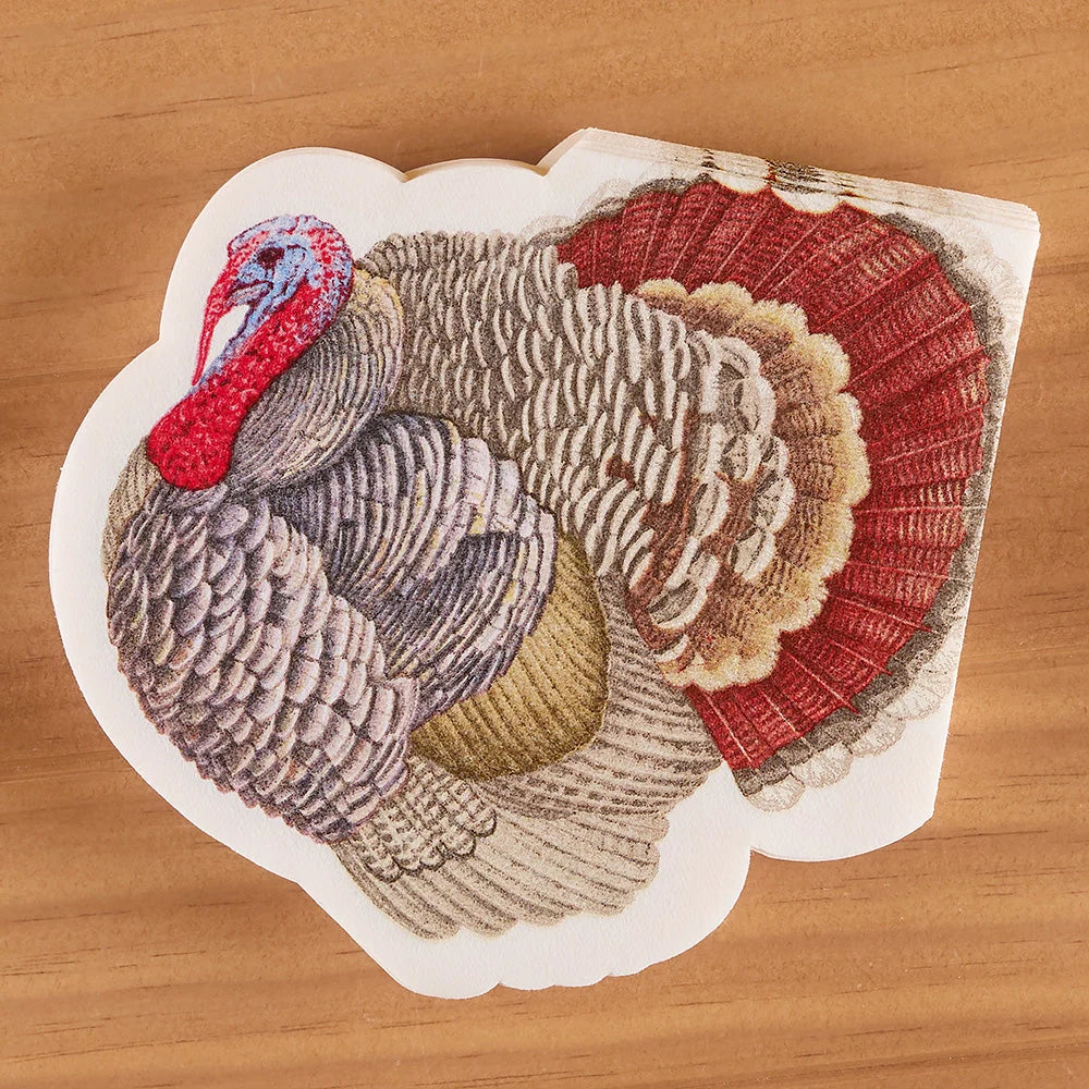 A die-cut sticker featuring a detailed illustration of a wild turkey, displayed on a light brown wooden surface.