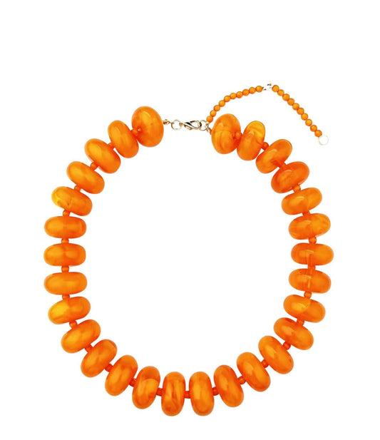 Orange beaded necklace on a white background