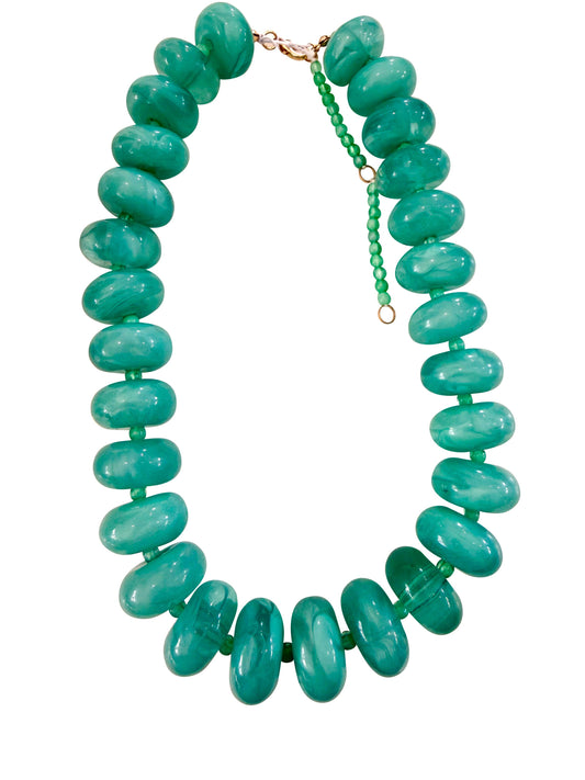 Green beaded necklace on a white background