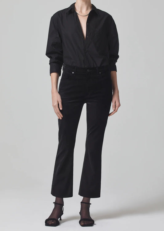 Person wearing a black shirt and black pants on a white background