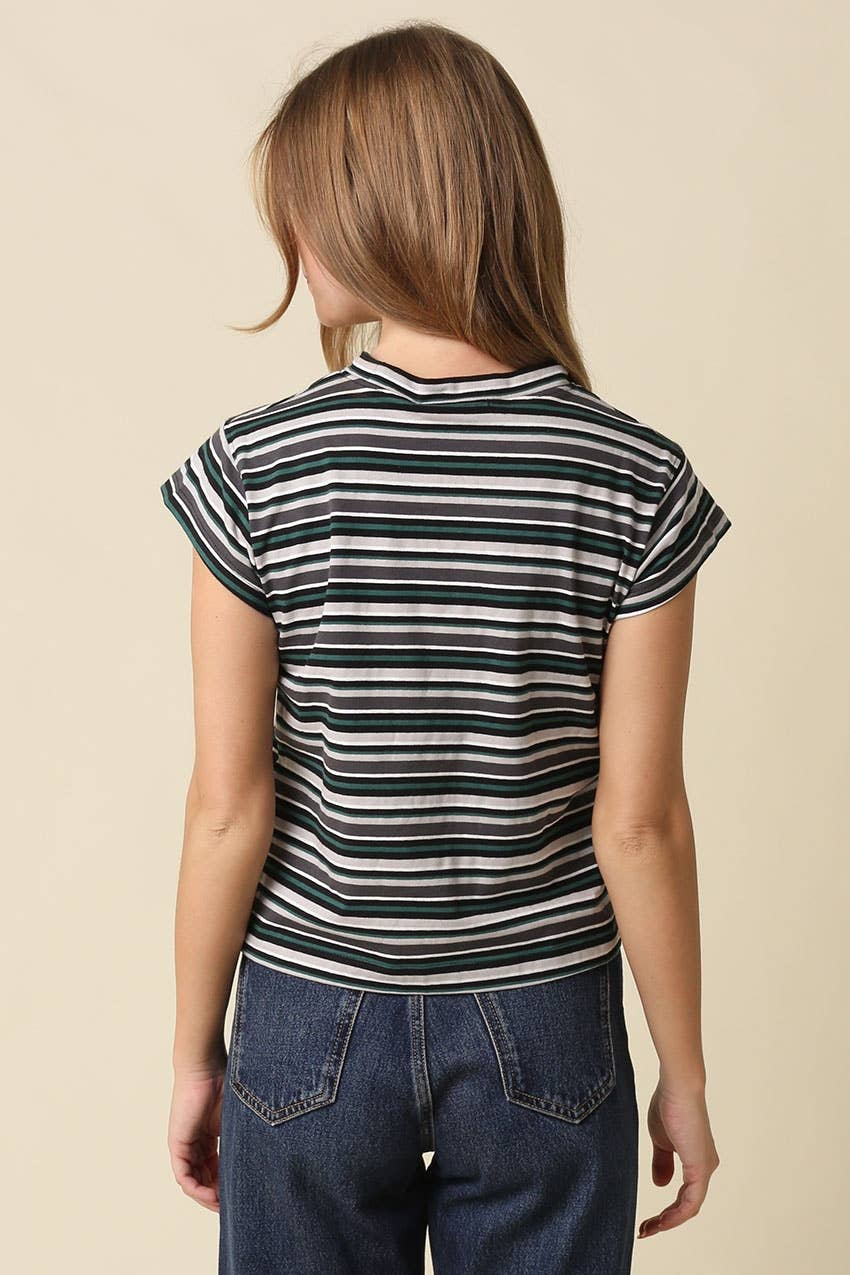 A woman shown from the back wearing a short-sleeve striped t-shirt with navy, black, and white horizontal stripes, paired with blue jeans, against a solid beige background.
