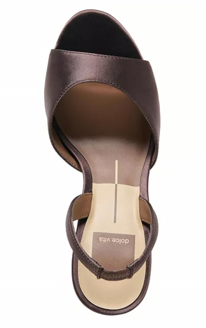 A single women's heeled sandal shown on a mobile shopping app screen, with product details including price, color, size options, and an 'Add to Bag' button. The sandal appears to be a dark brown or brown-mahogany satin slip-on style with a slingback/ankle strap and a light beige insole.