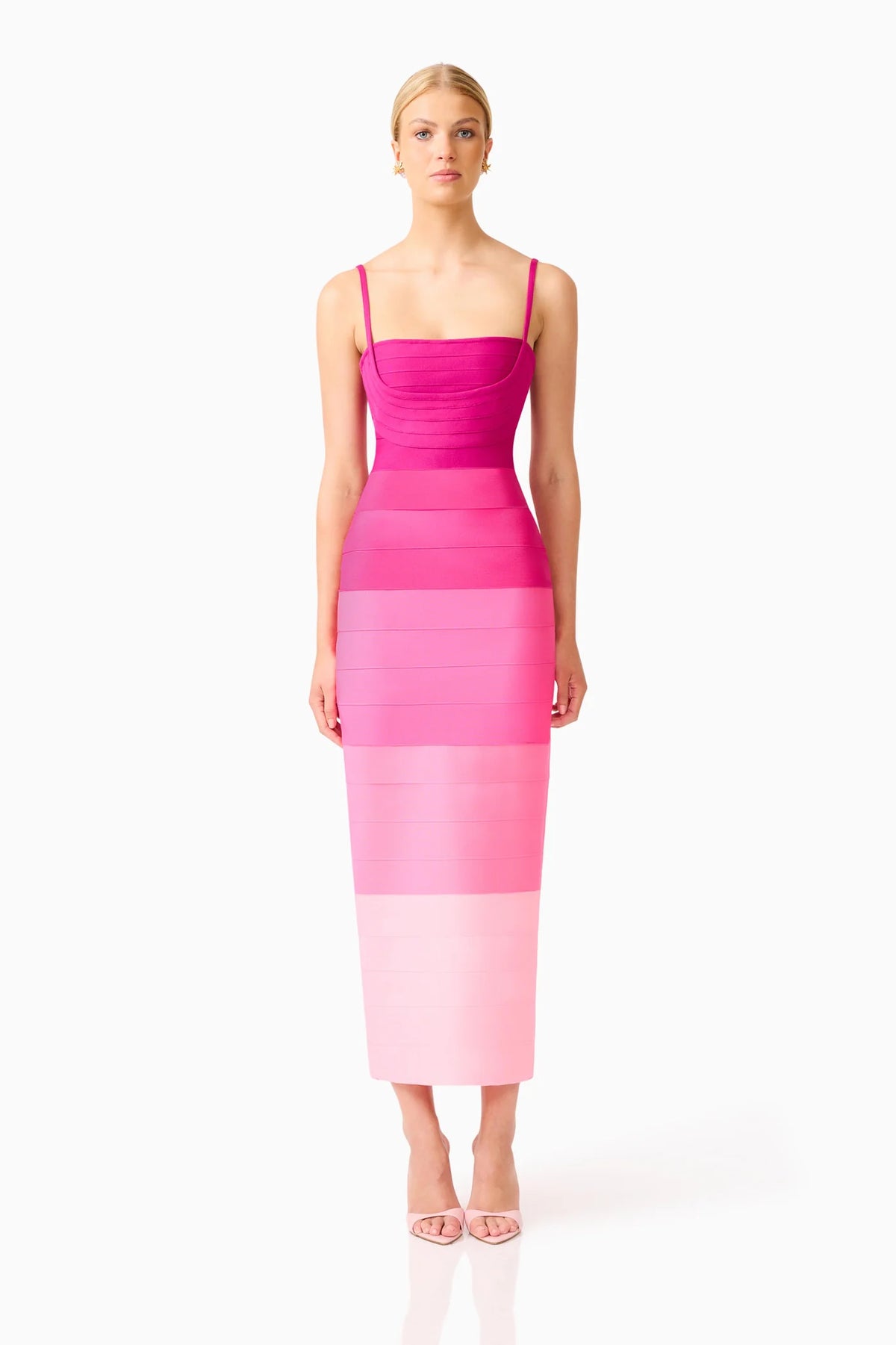 A model wearing a sleeveless, bodycon midi dress with horizontal color-blocked stripes in vibrant pink, magenta, and light pink, set against a plain white studio background.