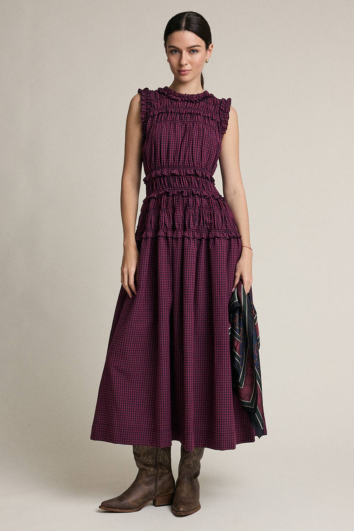 Woman wearing a purple dress with a plain background