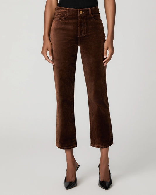 A model wearing brown cropped corduroy pants with a straight-leg fit, paired with black pointed-toe heels, shown against a light gray studio background.