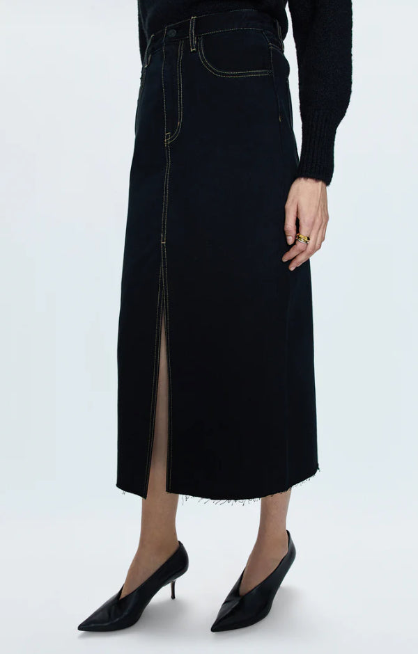 Person wearing a black skirt with a white background