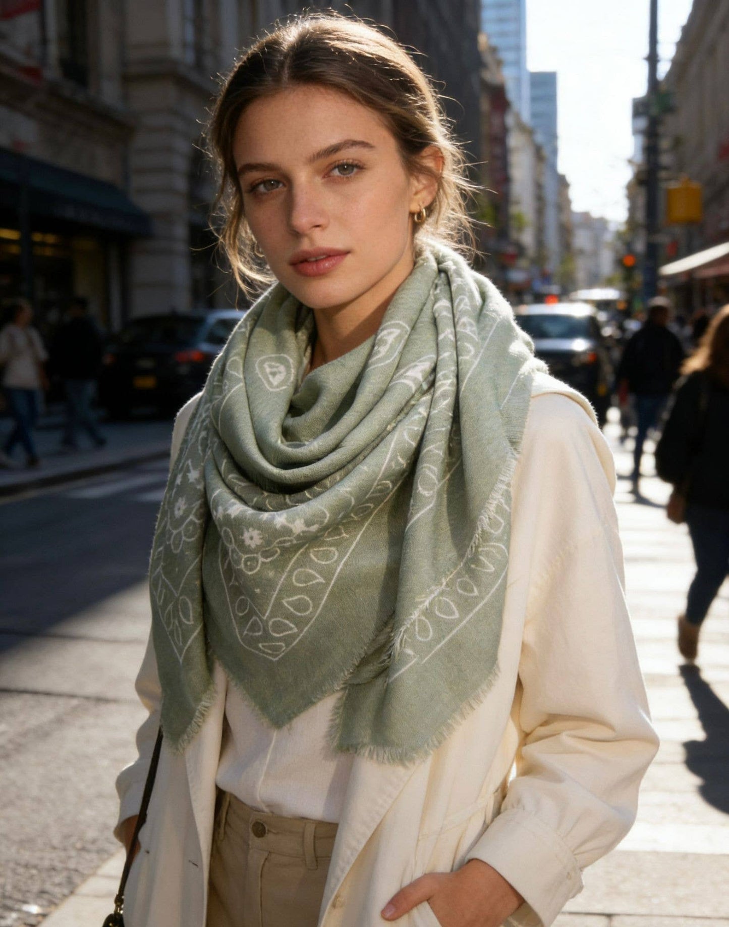 Woman wearing a green scarf on a city street
