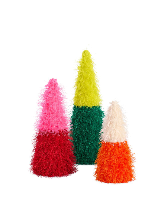 Three fuzzy, cone-shaped decorative trees in candy corn colors: one pink, red, and dark green; one lime green, dark green, and orange; and one cream, orange, and red. They are arranged on a plain white background.