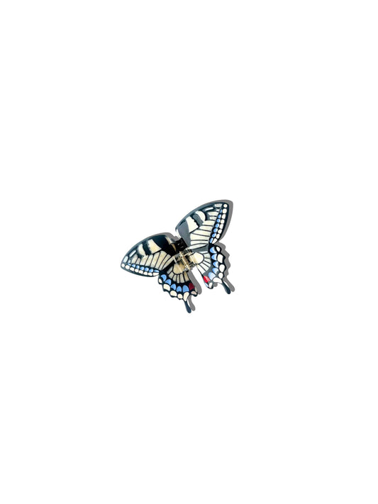 Butterfly-shaped brooch on a white background