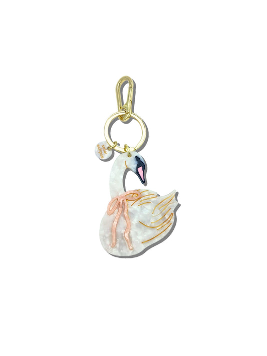 Swan-shaped keychain with gold accents on a white background