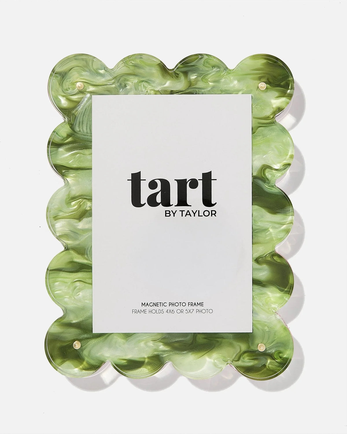 A scalloped-edge magnetic photo frame made of marbled green and white resin, shown with a white insert card displaying the brand name 'tart BY TAYLOR' on a clean white background.