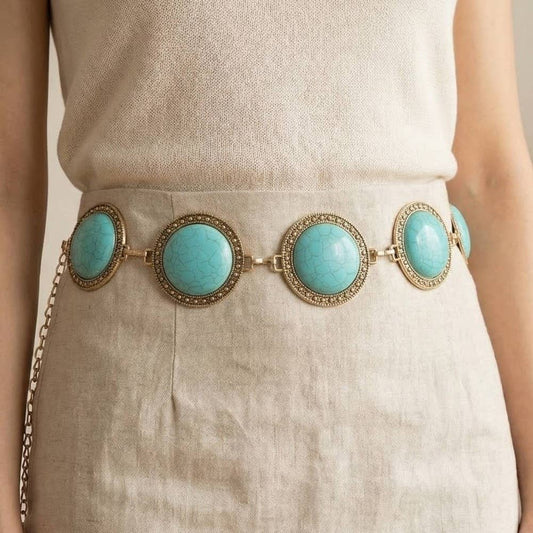 Turquoise stone belt with gold chain on a neutral background